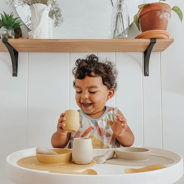 EzPz First Foods Set 100% Food Grade Silicone Baby & Toddler Suction Bowl with Built In Placemat - Oat