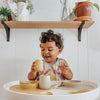 EzPz First Foods Set 100% Food Grade Silicone Baby & Toddler Suction Bowl with Built In Placemat - Oat